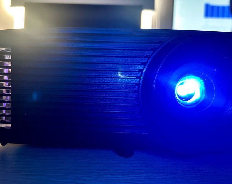 an optoma projector looked from front, lighting blue