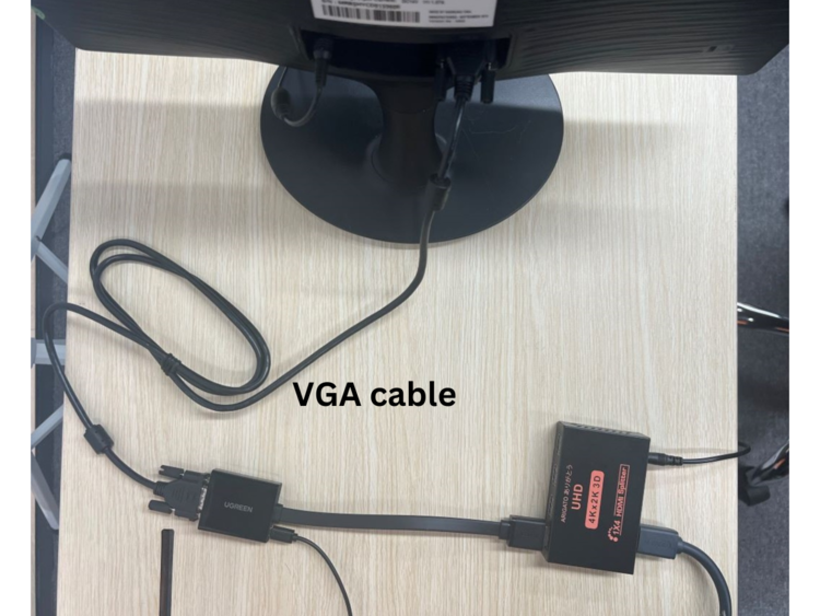 VGA cable connects from the input of the HDMI splitter to the VGA port at the back of the monitor