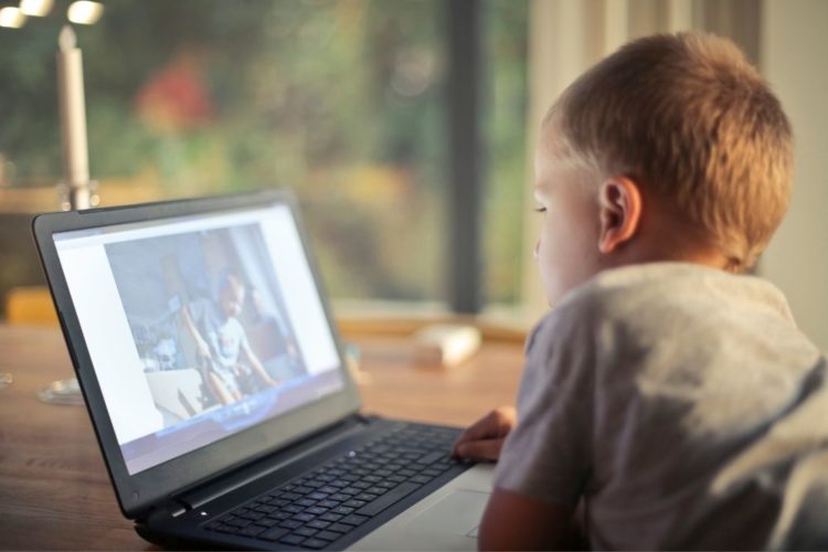 A boy watching video on laptop