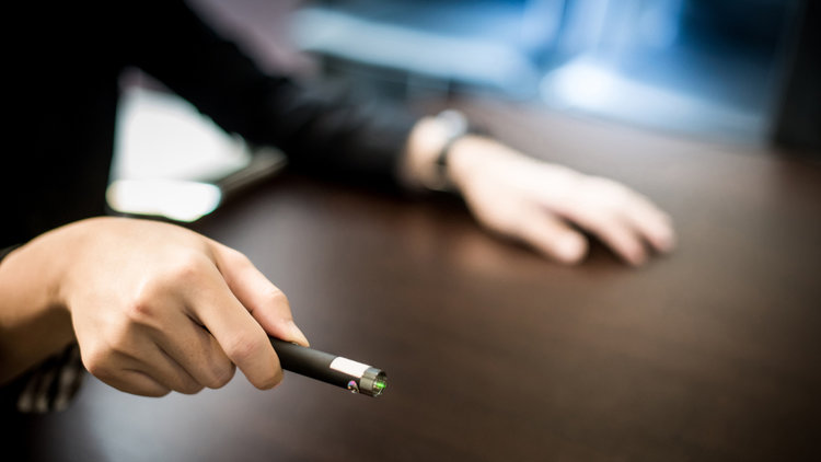 A man holding a green laser pointer