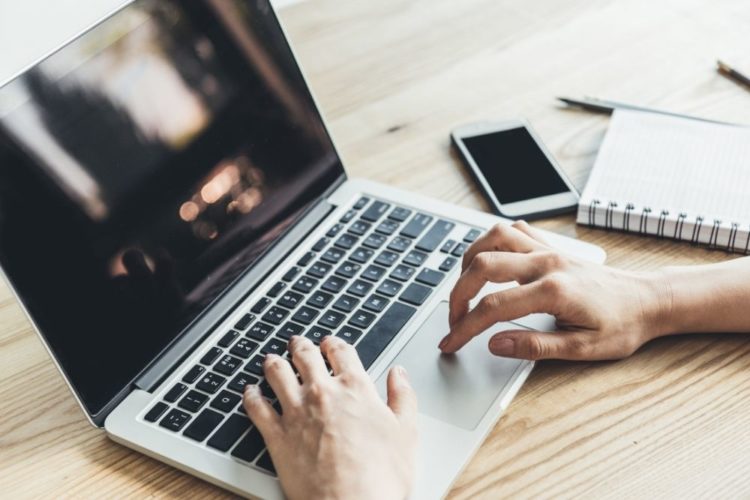 A man watching video on laptop