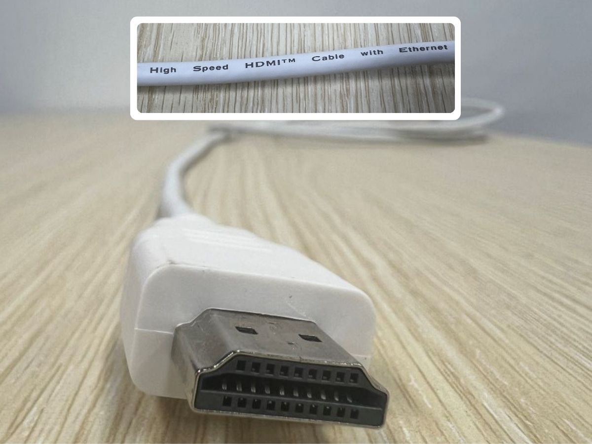 A white high speed HDMI cable on a wooden cable