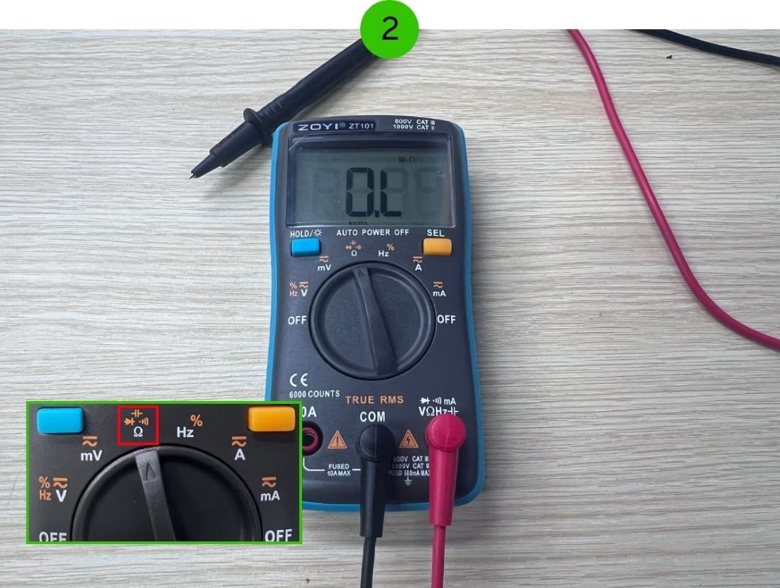 The multimeter is set to Resistance
