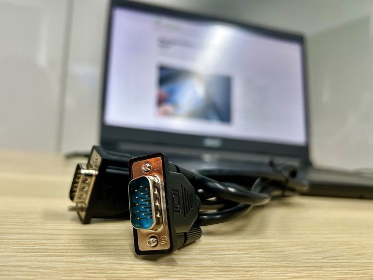 vga cable with a laptop in the background