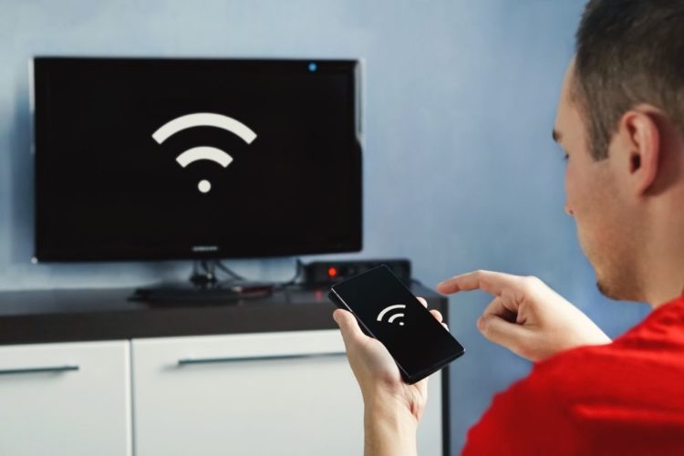 A Man connects TV and smartphone with Wifi