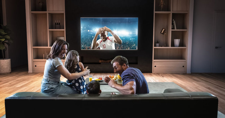 A family watching football on 4K TV