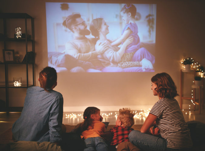 A family watching projector screen together