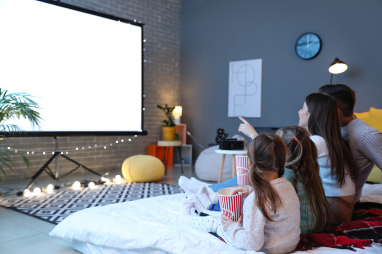 A family watching projector together in the evening