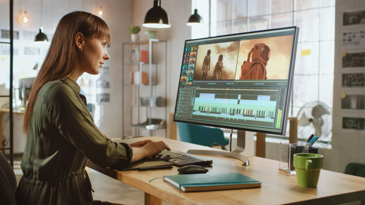 A girl using 4K monitor for editing video