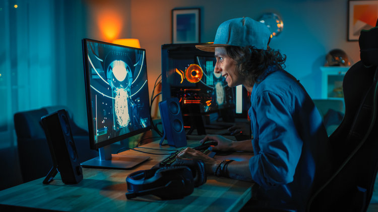 A man playing game on 4K monitor