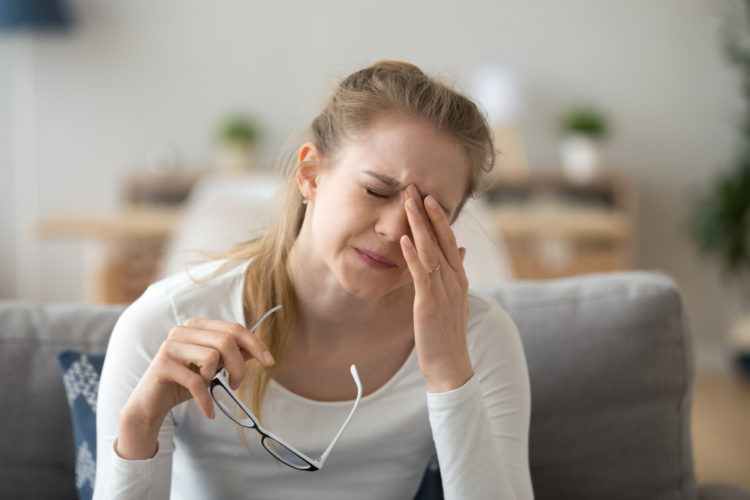 A woman having eye fatigue problem