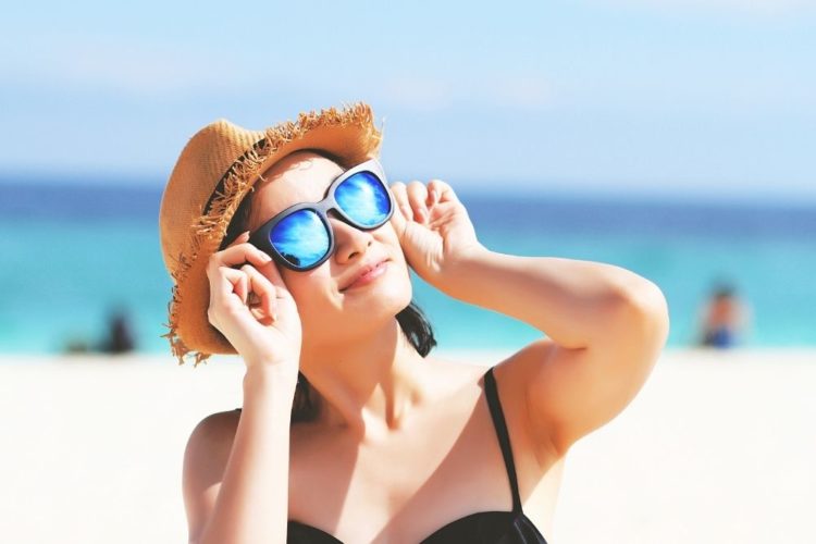 A woman wearing sunglasses at the beach