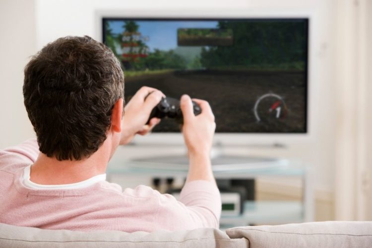 An adult playing game on TV