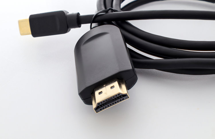 Black HDMI cable on a white table