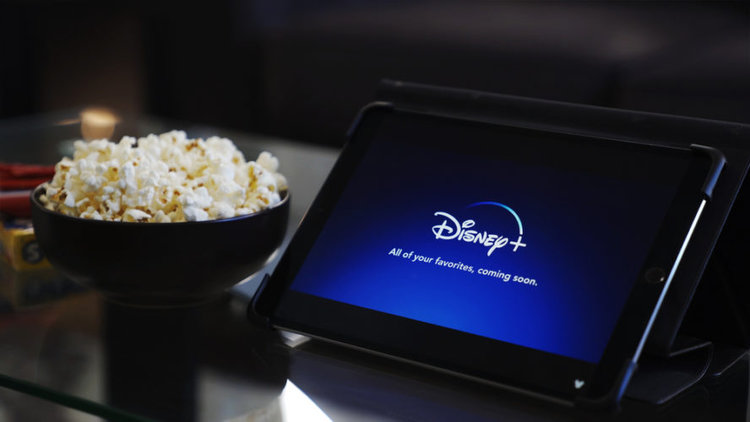 Disney Plus on tablet and popcorn