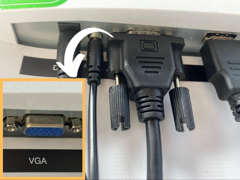 VGA cable is connecting to the VGA port on a monitor