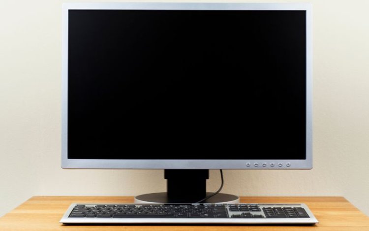 a computer monitor and keyboard on a table