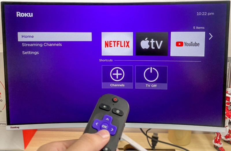 pointing a Roku remote to the Roku screen on a monitor
