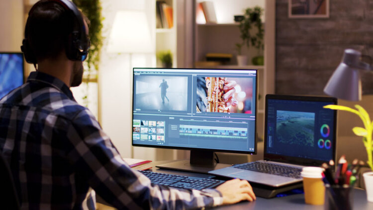 A man edit video on monitor