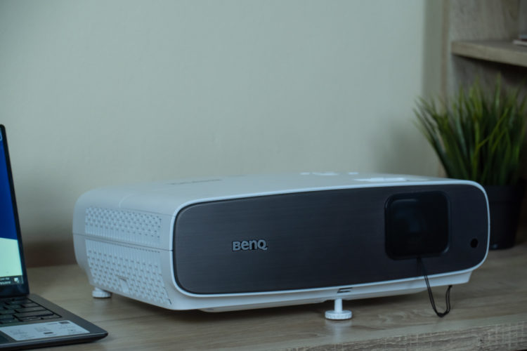 A white BenQ projector on a table