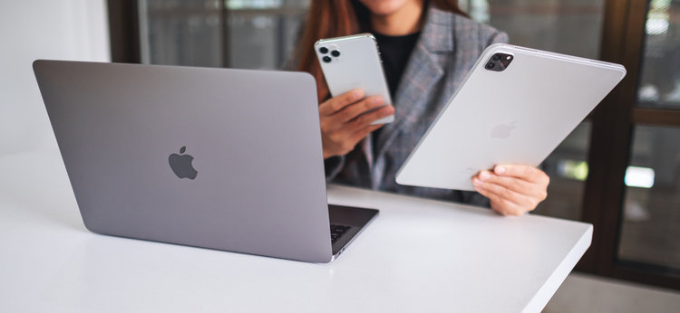 Apple devices are used by a woman