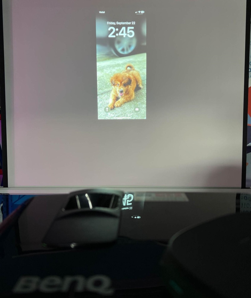 BenQ projector displaying an iPhone screen