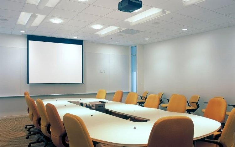 Bright meeting room with projector screen
