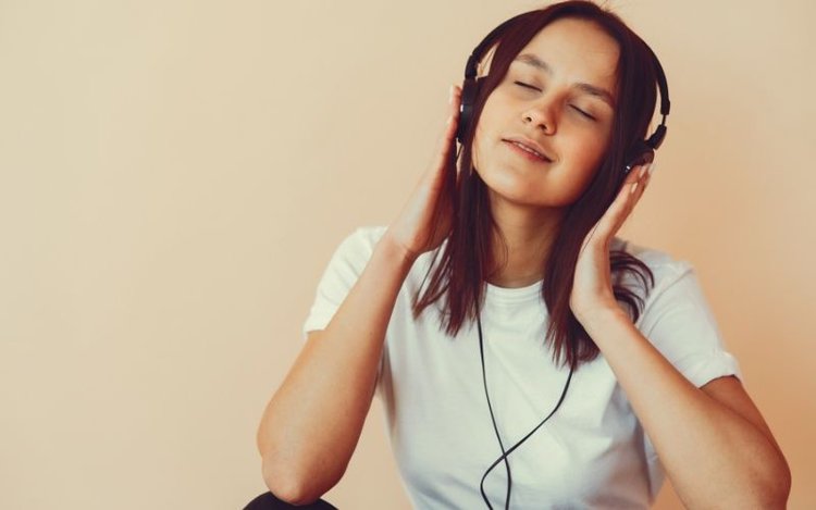 Girl is listening to music from headphone