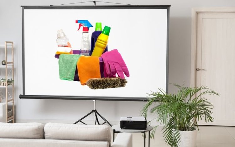 Projector screen in living room showing cleaning tools on screen
