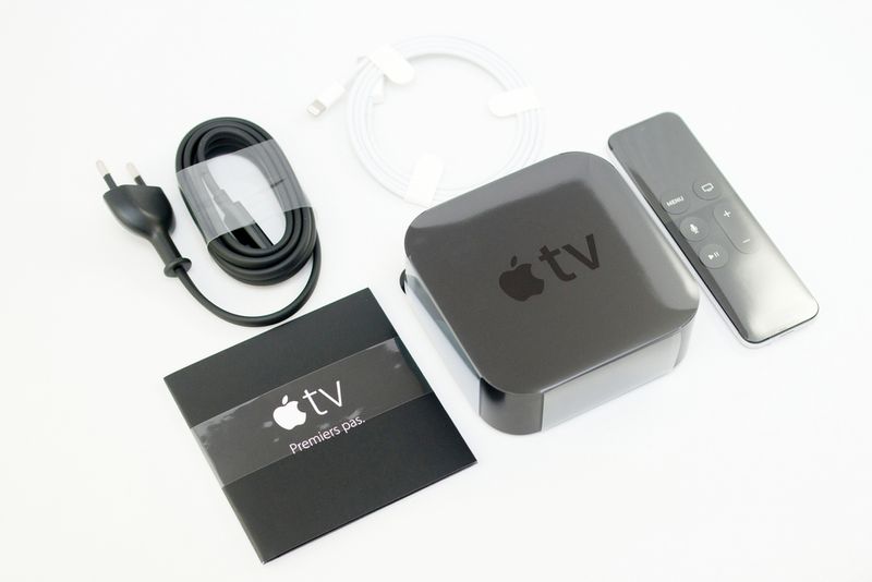 a Apple TV device, remote, power cord, instruction paper and lightning cable