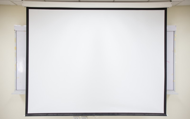 a white projector screen mounted on a ceiling