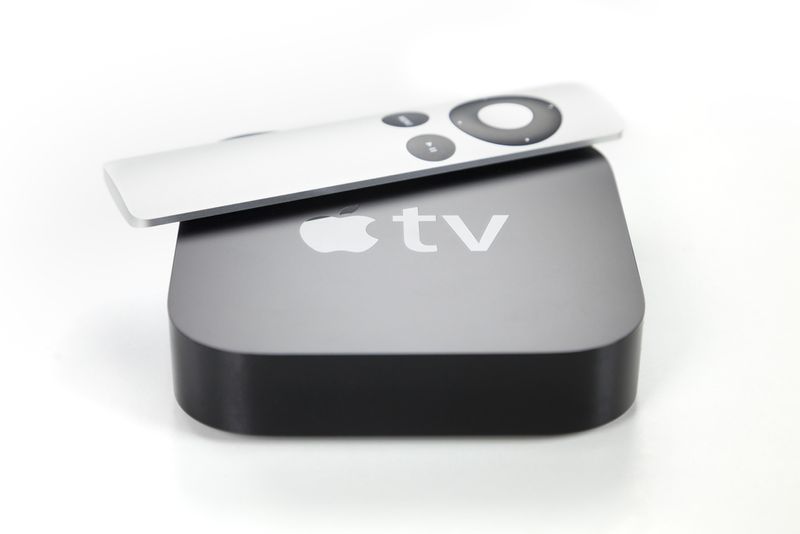 grey Apple TV device and remote