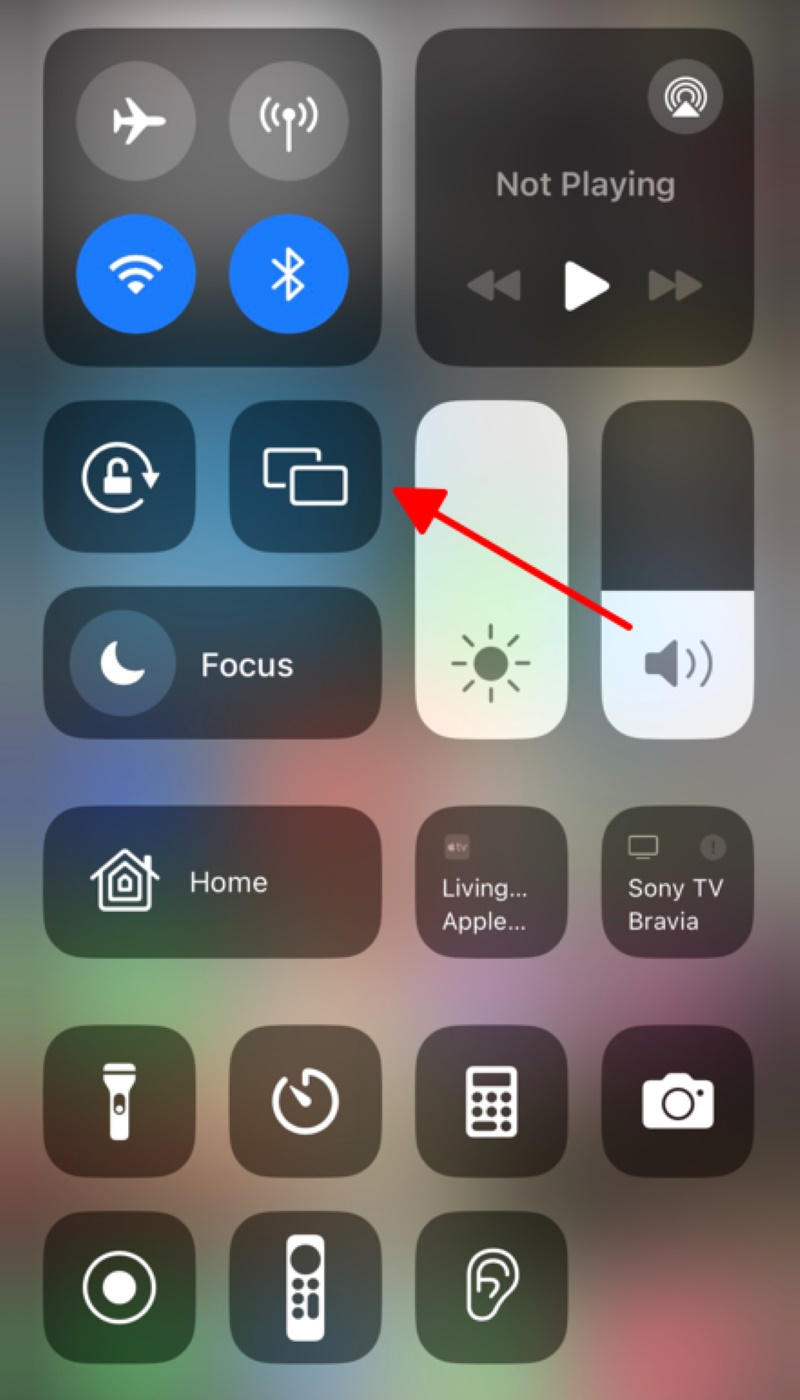pointing to the Screen Mirroring icon on the Control Center of the iPhone
