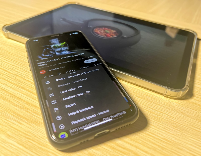 4K HDR YouTube labeled video on an iPhone screen with an iPad next to