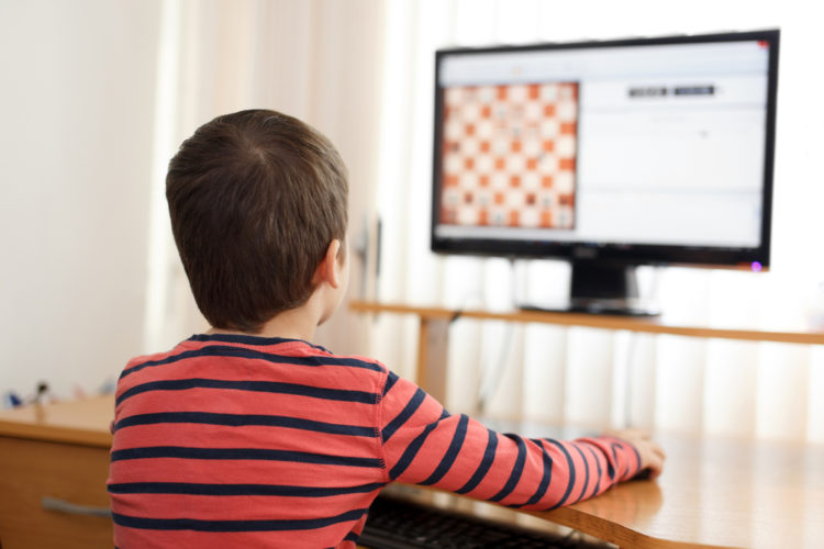 A kid playing game on 4K TV