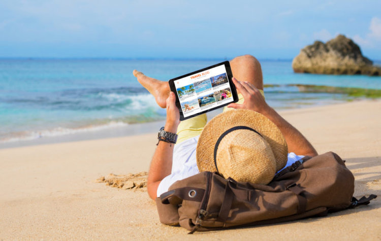 A man watching video on the beach