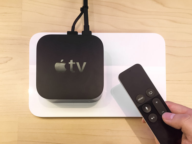 Apple TV box and remote on a table