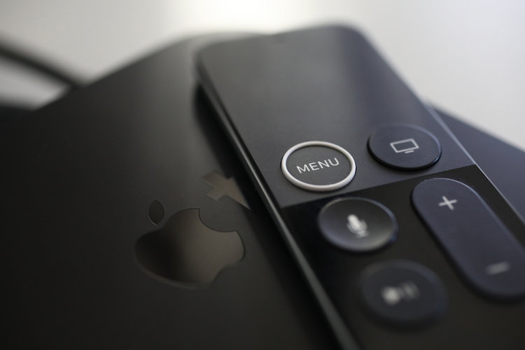 Close up view of Apple TV box and remote