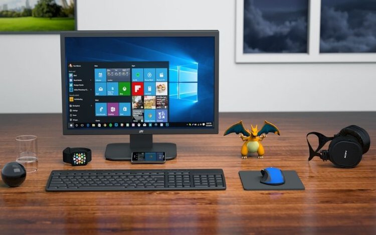 HDR monitor on desk with keyboard, little pokemon figure, headphone, mouse