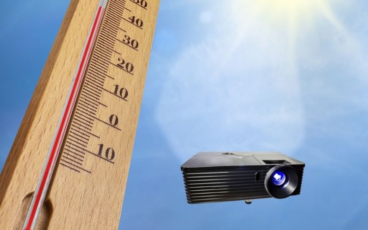 a projector besides a themo indicating hot temperature