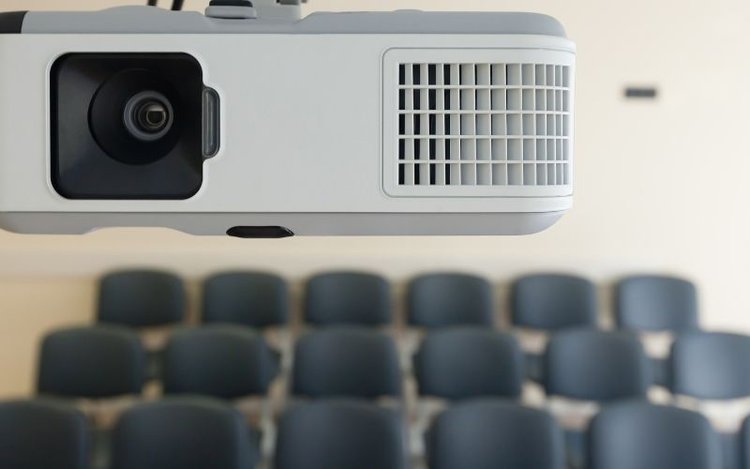 a white projector in a classroom