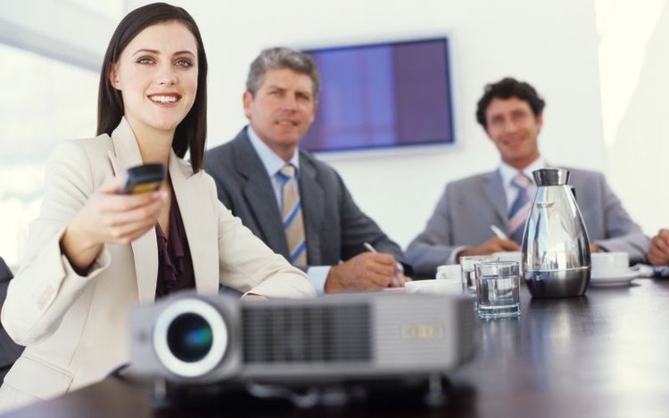 a woman reset a projector in conference room