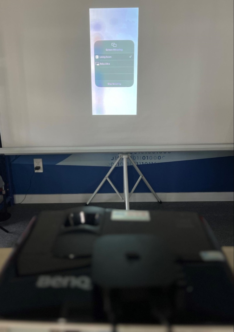 an Apple TV is connected to the BenQ projector and mirrors an iPhone screen