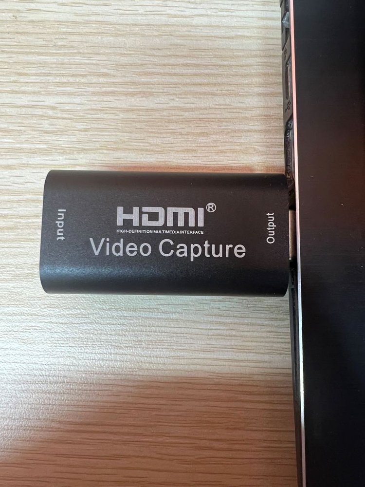 Capture card is being plugged into laptop via HDMI port