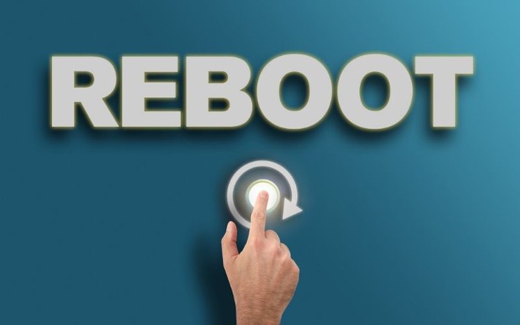 man clicking on reboot button