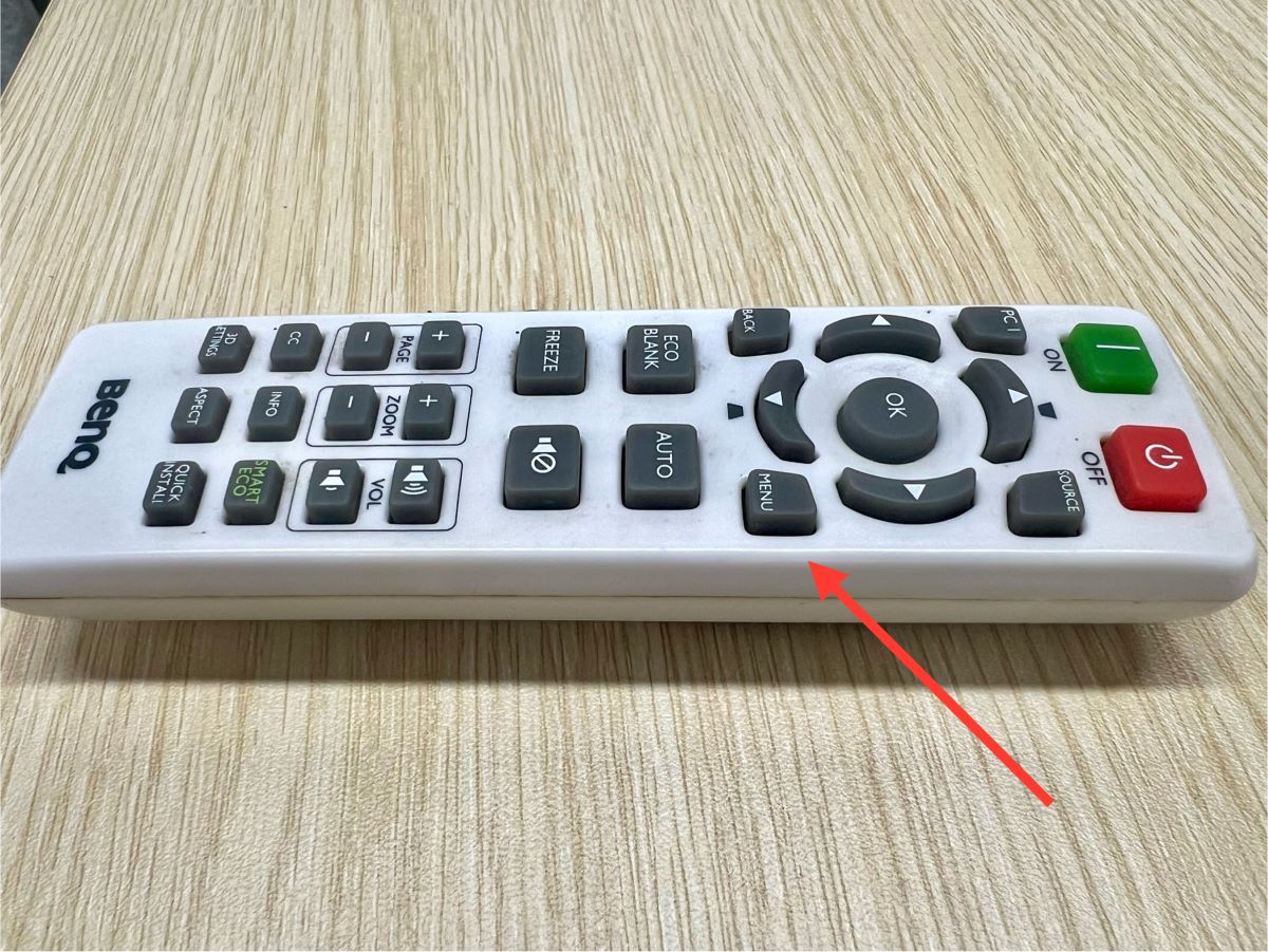 menu button is pointed at on a benq projector remote