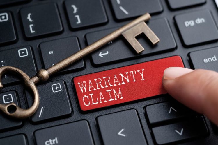 red warranty claim button on black keyboard and yellow key