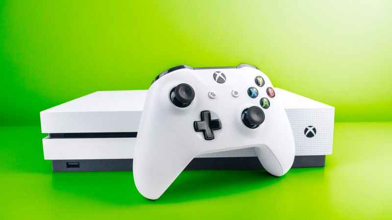 white Xbox One S in green background