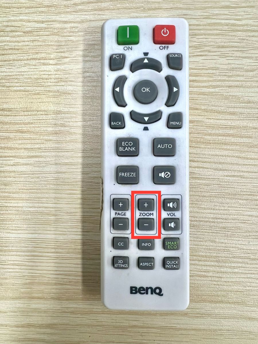 zoom buttons are highlighted on a benq projector remote