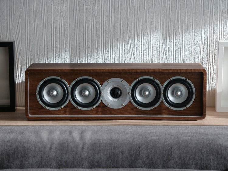 A black speaker on a sofa